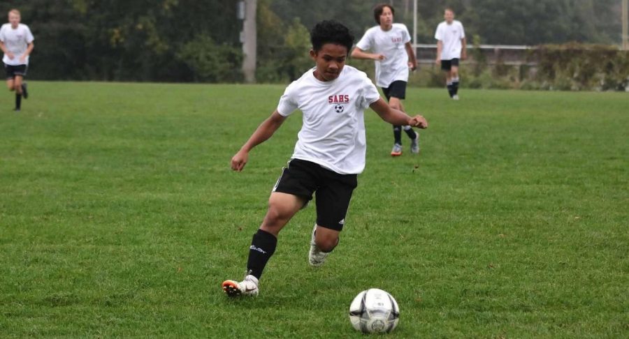 Junior Gian Sabling plays his favorite sport that he grew to love after moving here. He enjoys playing soccer with his friends and it makes adapting easier. At school having structured sports is exciting for students who move here.