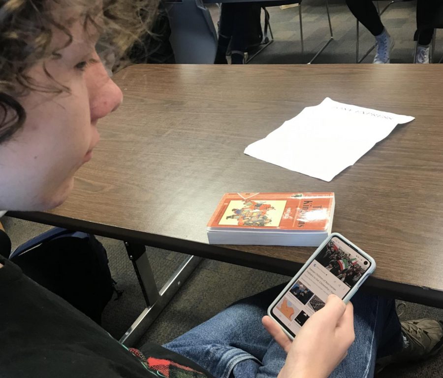 Junior Sam Hickey reads about the Iran situation on his phone. While American news has a strong focus on foreign policy, these issues do not seem to have a strong influence on voters. 