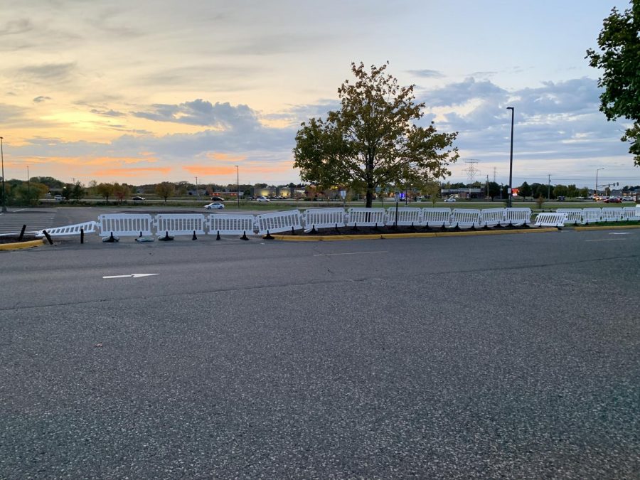 Parking lot barriers restrict access to road crossing. These barriers are intended to allow vehicles to pass easily without fear of students crossing outside the crosswalk.