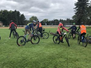 Members of the Mountain Biking team prepare for one of their daily practices. The team must take every available chance to practice to compensate for weather-based cancellations.