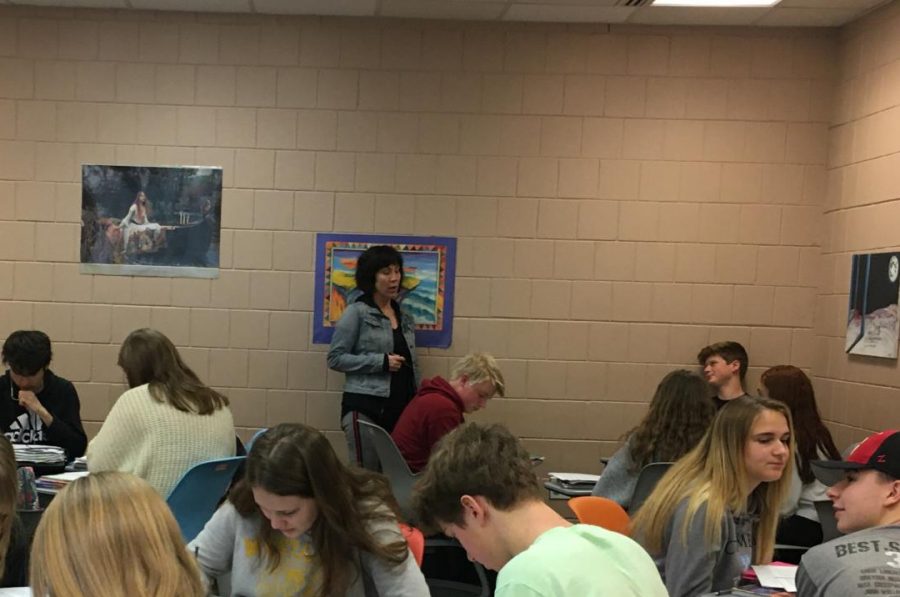 English teacher Kim Thompson talks with her English 10 students. She often works in small groups of students or up in the front of class.