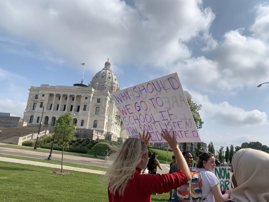 Senior Grace Roske holds up a sign that reads, Why should we go to school if you dont listen to the educated during the climate strike Sept. 20. The strikes aims to show lawmakers that people care about the planet, and pressure them to take action.