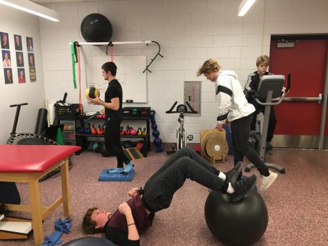 Students utilize after school assistance from physical therapists Dec. 11 in the athletic training room. They are given exercises to complete throughout rehabilitation to build strength.