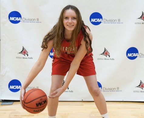 Senior Delaney Wagner takes pictures in her new college uniform after signing with The University of Wisconsin-River Falls. After three years of playing at the varsity level for the ponies she will play college basketball at the division III level starting next fall.