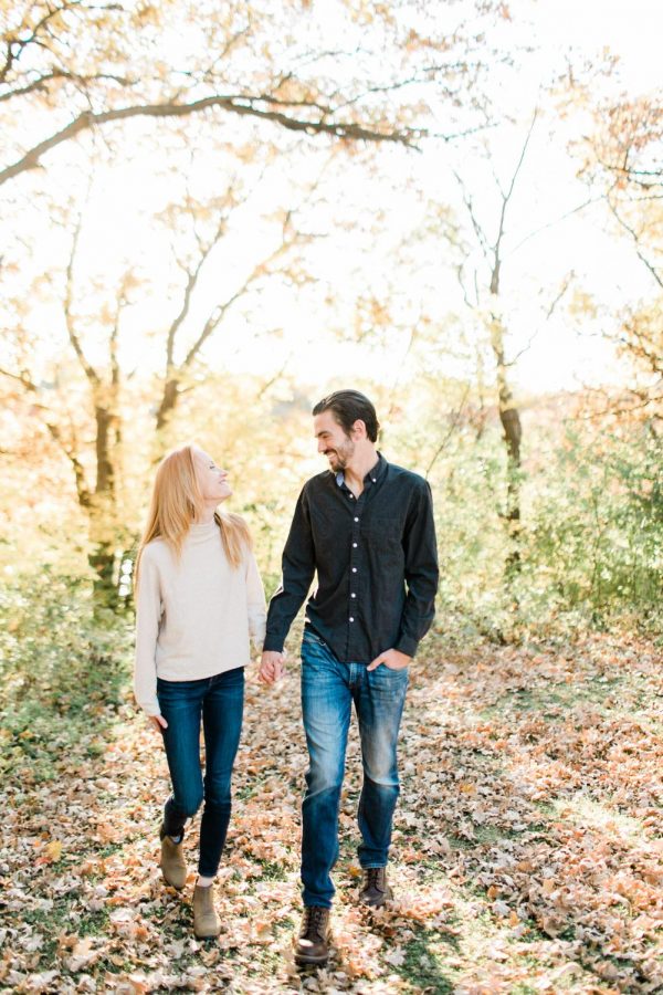 The bride and groom to be, Ryan Miller and his fiancé Jillian take an autumn stroll through the woods in this joy-filled photo. These two definitely seem like the perfect match!
