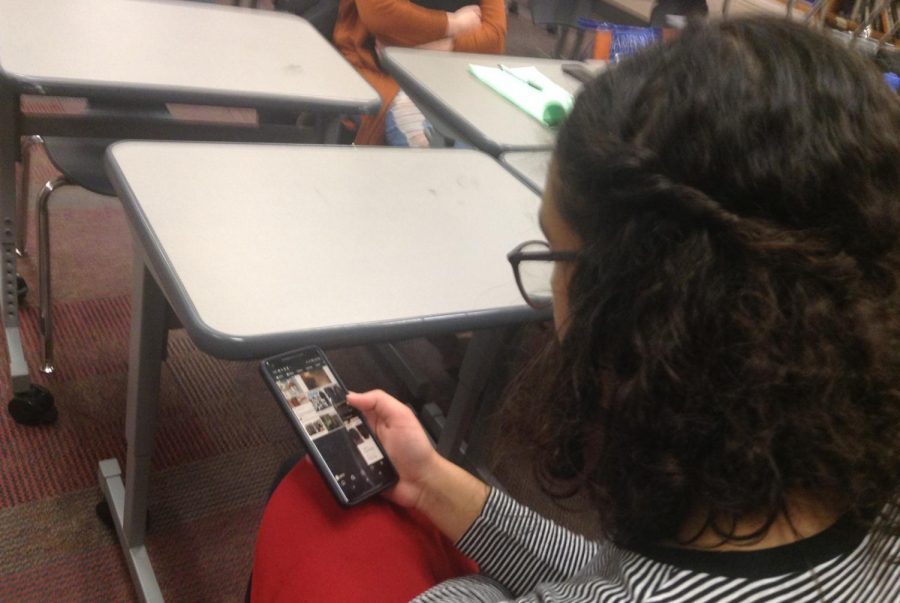 Freshman Ava Roots browses her Instagram feed. Every day over a million stories are uploaded.