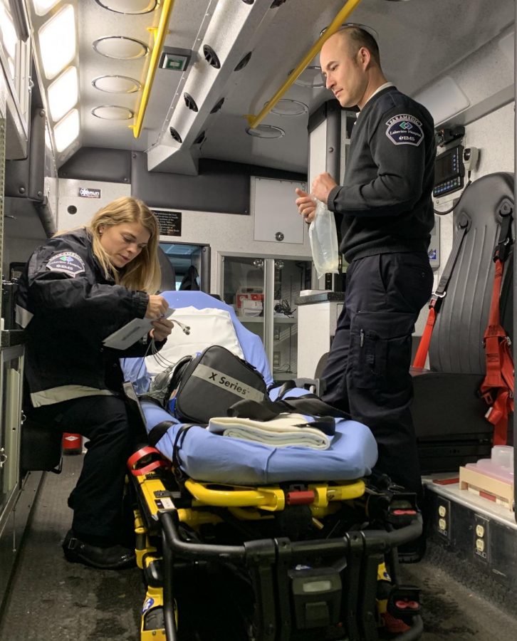Just after coming back from a call, paramedics Brittney Bielenberg and Tim Hoelzel restock and prep the ambulance for their next call. 