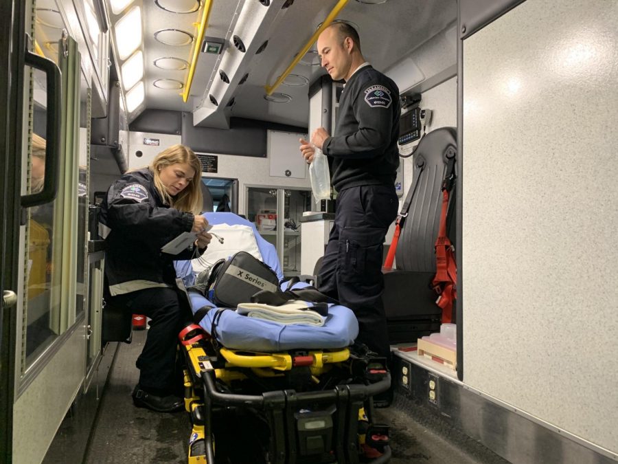Just after coming back from a call, Paramedics Brittney Bielenberg and Tim Hoelzel restock and prep the ambulance for their next call. 