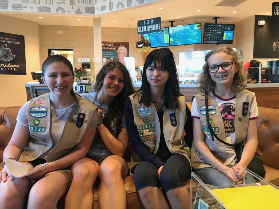 Juniors Emily Shanley and Johanna Teegarden smile big with other Girl Scouts for their leader. Teegarden and Shanley have been in Girl Scouts together since first grade.