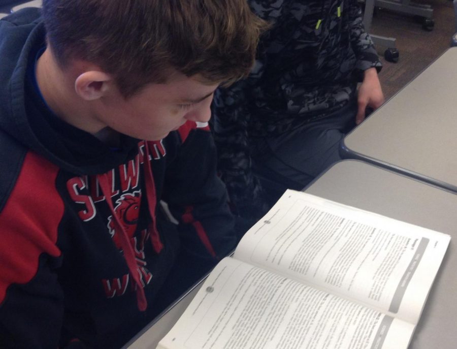 Junior+Tyler+Olson+studies+an+ACT+Prep+Class+textbook.+Many+students+take+time+out+of+their+classes+to+study+for+the+ACT%2C+which+interferes+with+their+focus+and+learning+experience+during+class+time.