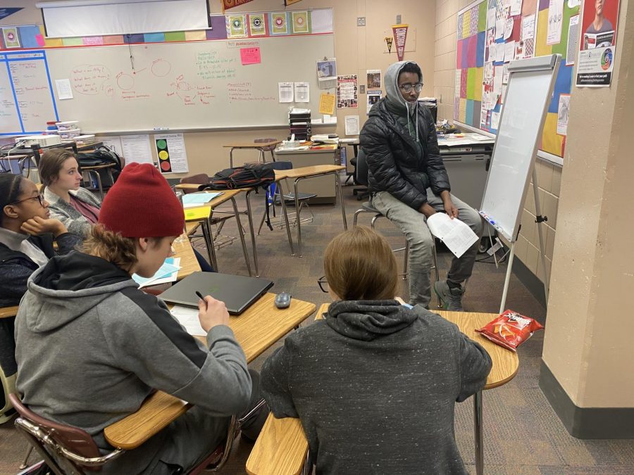 Students sit around a whiteboard in AVID as they help their classmate with a math problem. This activity is what AVID teachers call tutorials, the goal being to help students pick apart a question to determine what it is that they do not understand. Teachers believe that this strategy has benefits for all students.