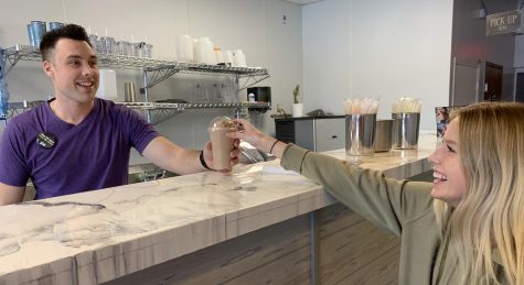 Junior Ava Nyberg gets her protein shake from the owner of Liftbridge Nutrition, Jon Ransom. The location just opened and they offer a range of healthy shakes and teas as well as wellness coaching.