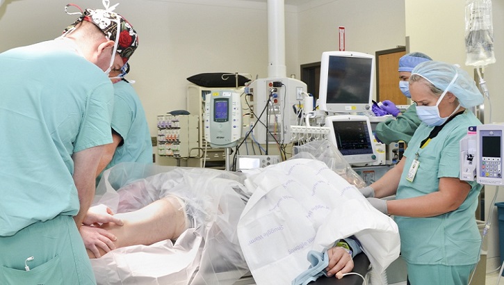 Nurses prepare for a surgery amid the COVID-19 crisis. Surgeons and many other members of the healthcare industry have been furloughed due to many hospitals cutting certain services.