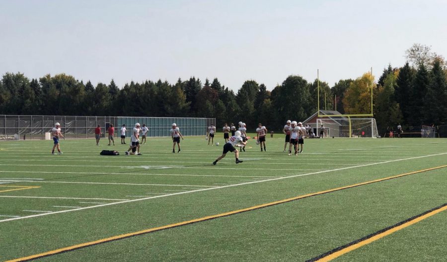 This is a varsity football practice on the practice fields at SAHS. The players are working on running short passing routes.