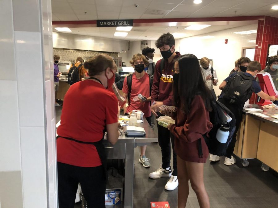Juniors at Stillwater Area High School, Amelia Bretl, Nick Koehn and Connor Quaderer take advantage of the free lunches provided due to COVID-19. Each student can receive one entree but must take one serving of fruits or vegetables. 