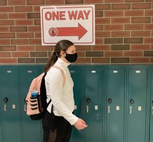 Students walk down one way directed hallways in SAHS to follow the safety precautions for Covid-19, examples of the precautions set in place are; wearing a mask and many more.