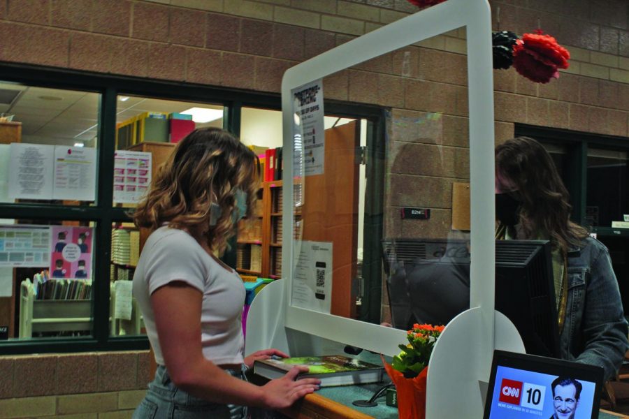 Junior Mara Scott picking up a textbook from the Library on Monday the 12th. As well as many other online students.  
