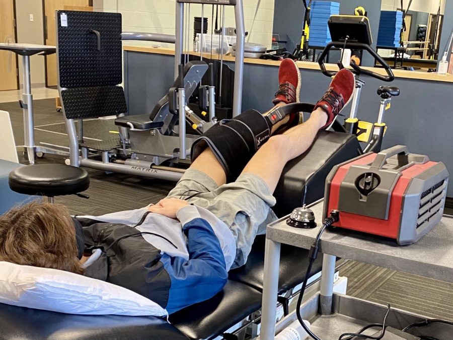 Photo credit to Beth Dierkhising.
Drake takes part in physical therapy twice a week which will help him regain strength and mobility. Pictured he is using an ice machine to reduce swelling after therapy.