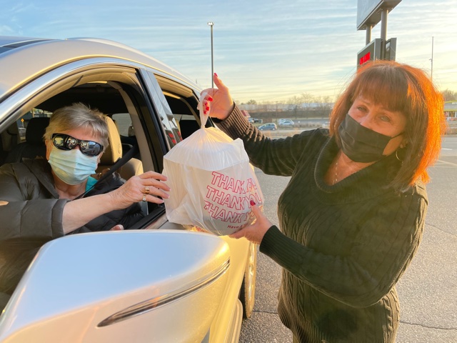 A Joseph’s customer (left) is having her food for curbside pickup handed to her by Mary Kohler (right) of Joseph’s. Many will recognize this situation, as curbside pickup has become a more popular way of ordering food from restaurants in the time of the pandemic.
