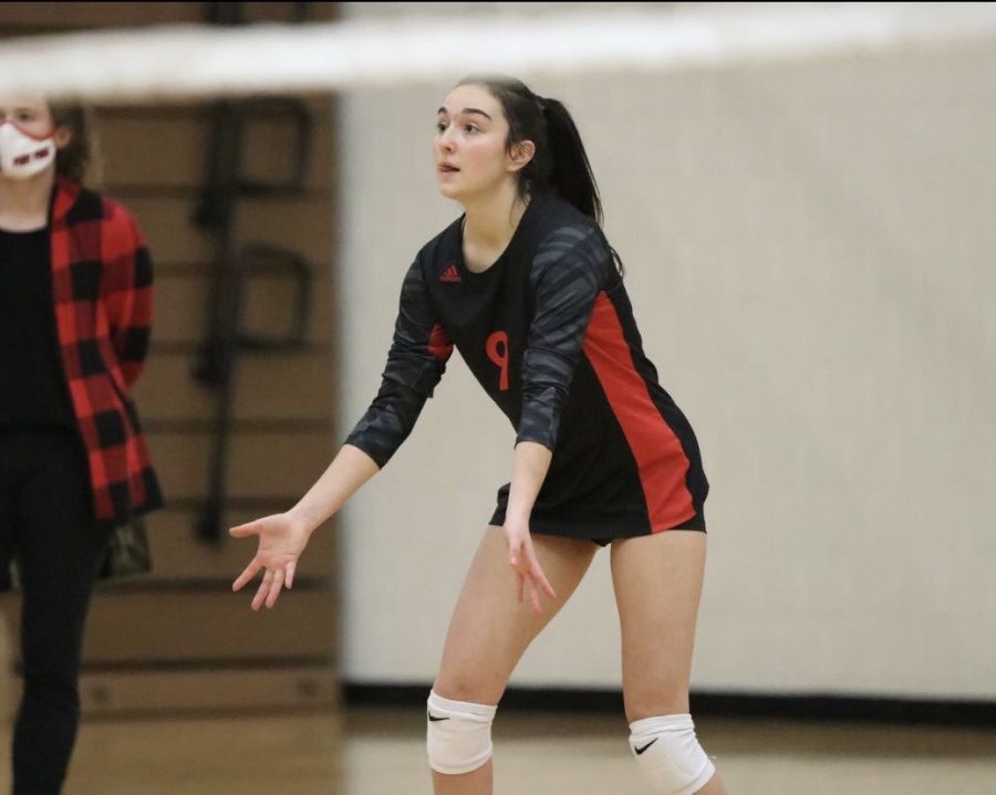 Senior Joelle Carpenter on the court in an away match versus Park High school, down and ready for a pass in one of the last games on the season.