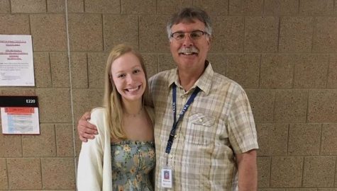 Teacher Mike Kaul is standing beside his former student Mallory McKay.  