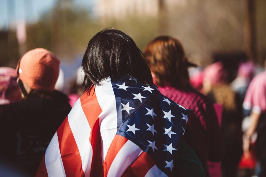 A woman wearing an American flag. American democracy is a point of pride for many Americans.