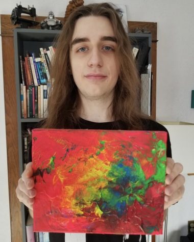 Junior Jackson Duin shows off one of his favorite paintings titled Light Up The Day. Duin recently curated an exhibition at Art Reach St. Croix, the youngest to do so at the gallery.