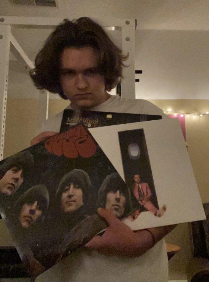 Angus Pitulla holds some of his favorite vinyl albums. From left to right: Rubber soul by the Beatles, Late Registration by Kanye West, and Swimming by Mac Miller. 