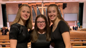 Then-sophomores Marena Saeger, Josie Crombie, and Carley Saeger perform at their last choir concert before COVID-19 became a global pandemic, during November of 2019. 