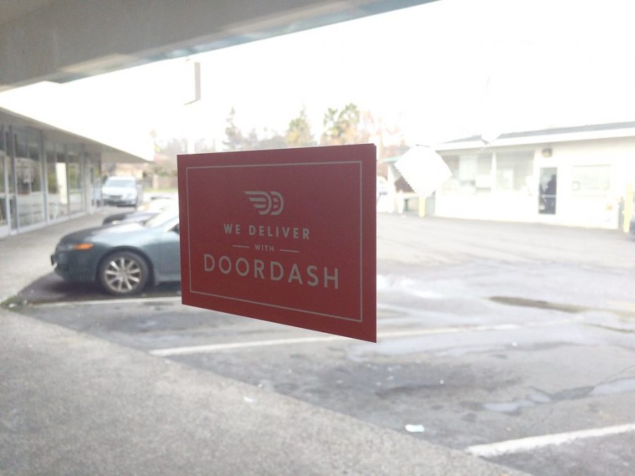 DoorDash advertisement sticker on restaurant window.