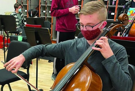 Senior Alex Steil works on his homework during class. He also practices cello before Con Amici rehersal.