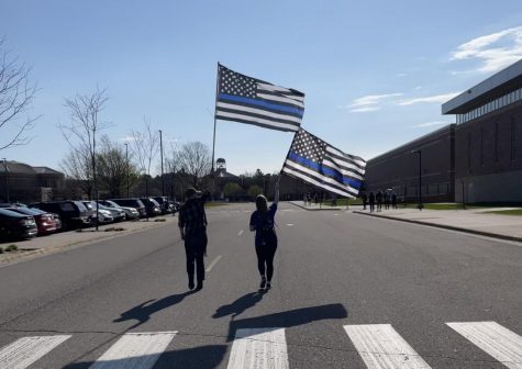 Local high school students hold thin blue line flags during a Back the Blue walkout. Thin blue line flags are seen as support to law enforcement and a sign of respect for those who sacrificed their lives.