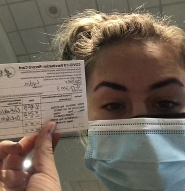 Lydia Geiser holding her fully filled out vaccination card proudly after her second and final dose of the vaccine on April 24, 2021.
