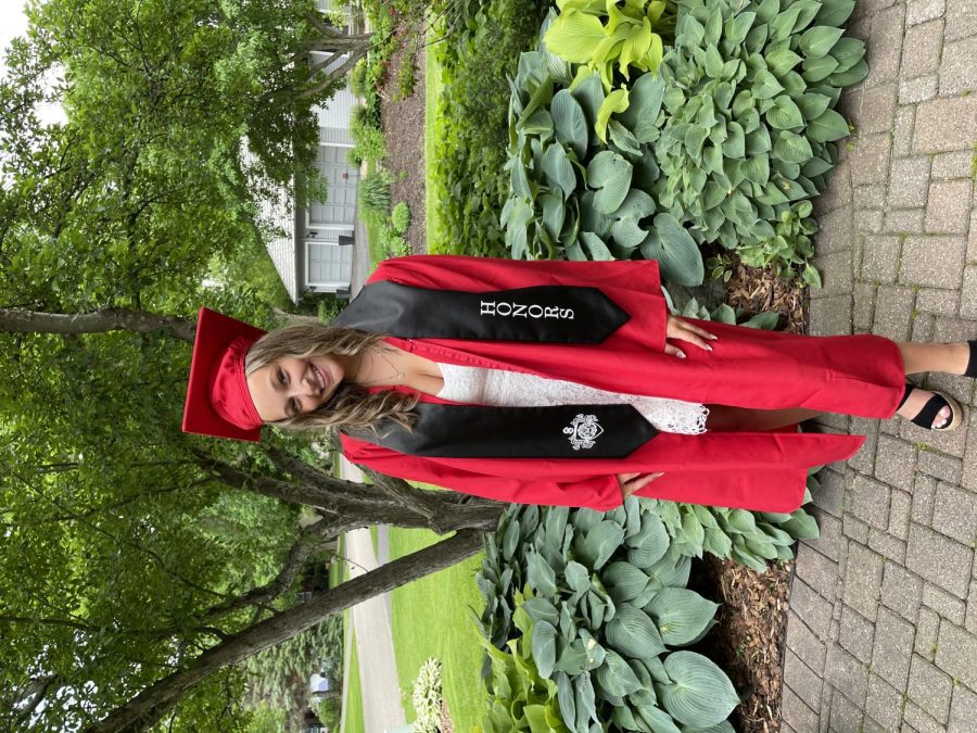 Senior Emma Kindler in her last day of school in your cap and gown.