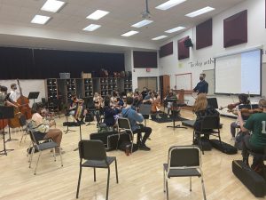Ryan Jensen has been hired to be the new Symphonic and Concert Orchestra conductor at SAHS. He joins the Varsity orchestra during their class period and conducts music with them.