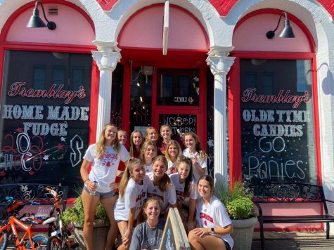 The girls lacrosse team decorates Tremblays Candy Store on Sunday before homecoming. This helps spread pony pride throughout the city.  