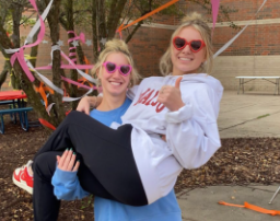 Junior student council members Keira Jelinek and Ellie Burg decorate the main courtyard for the dance. They added streamers and backdrops to make the dance feel normal again, even with being hosted outdoors.