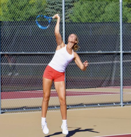 Senior player Lizzie Holder serves at a varsity match. Jana Myers and Lizzie Holder recently placed third in section finals.