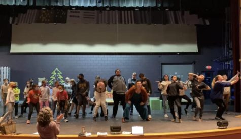 The cast of Elf: The Musical at Ashland Productions rehearsing a musical number.