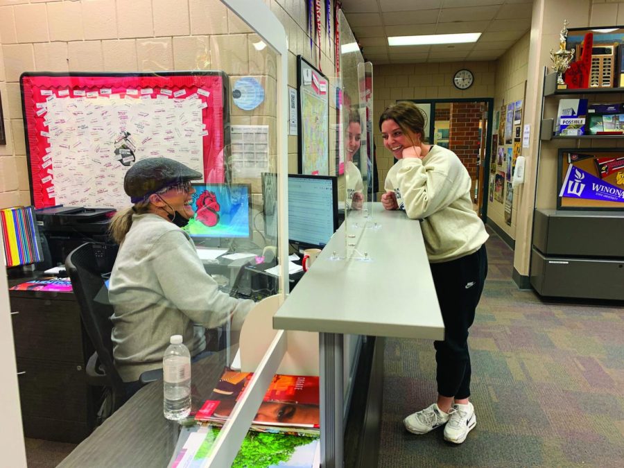 Senior Izzy Appert is talking to Amy Carr by he desk in the College and Career Center. Appert is discussing her plans for college with Carr.