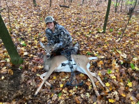 Katherine Miller poses with the doe she harvested while bowhunting.