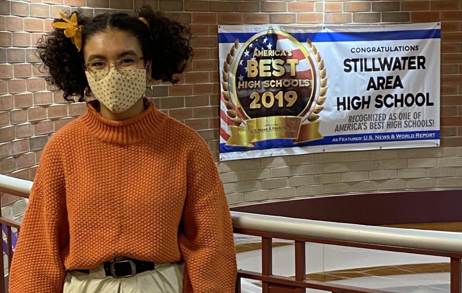 Junior Ava Roots received recognition from the College Board. Here she is pictured in front of Stillwaters Americas Best High Schools 2019 poster.