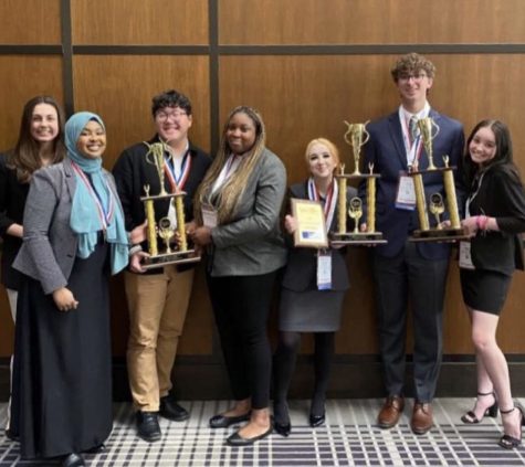 BPA members, seniors, Maxine Osei and Jay Lohr, juniors, Mushtaq Ibrahim, Abbey Kovalak, Philip Evitson and Kaylee Kellog stand with trophies that represent their success in a competition allowing their advancement to Nationals.
