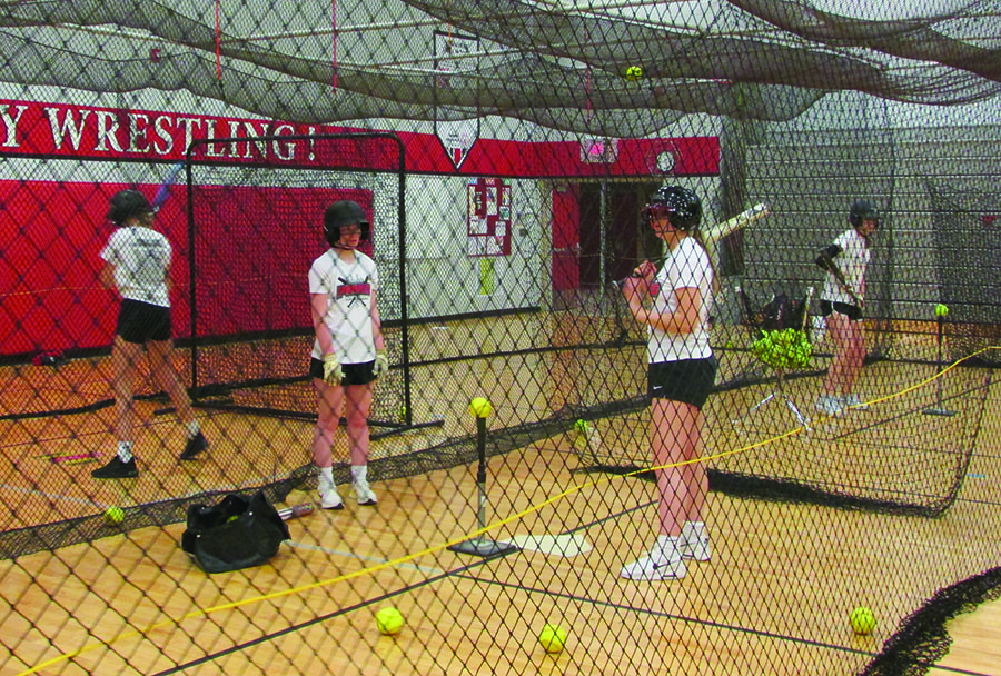 The girls softball team practices everyday after school. They practice inside until the weather allows them to hit the field. 