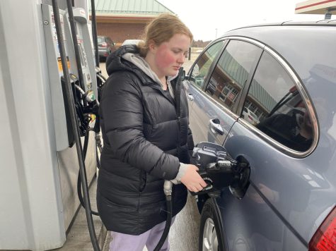 Junior Sara Norton gets gas at the Kwik Trip in Oak Park Heights on March 23. Gas was $3.99/gallon at this location.
