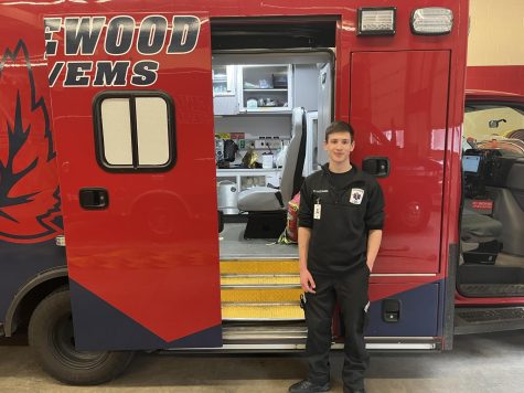 Senior Richard Hartmann stands in front of a red and blue ambulance. Inside shows the equipment used during their trips.