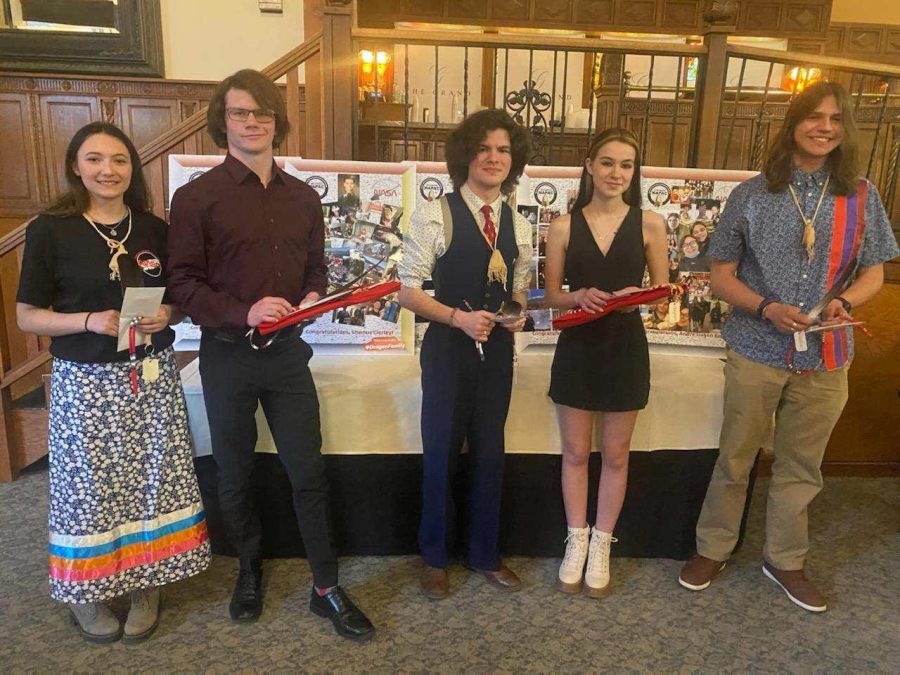 NASA seniors are lined up holding their eagle feathers.