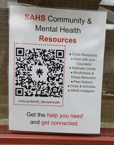 The Stillwater Area High School community and mental health resources QR code taped to a classroom window. These can be found in every classroom in the building for whenever a student needs them.
