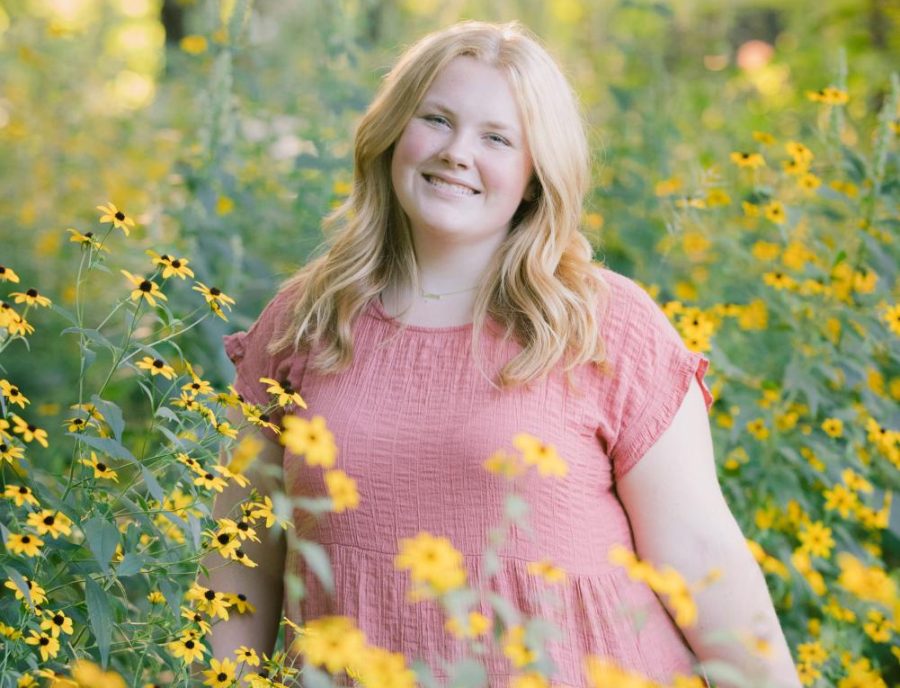 Student Sara Norton in a field of flowers.