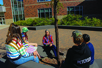 Teacher Ing-Mari Ryan brings students outside during her CIS Orientation to Education class.